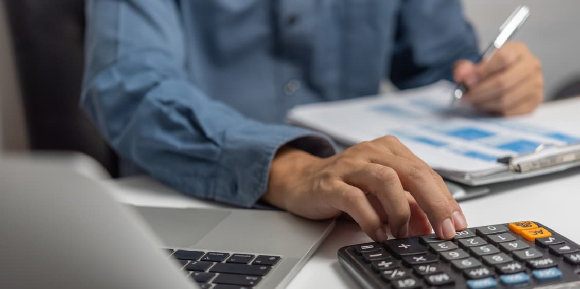 Businessman working on calculator