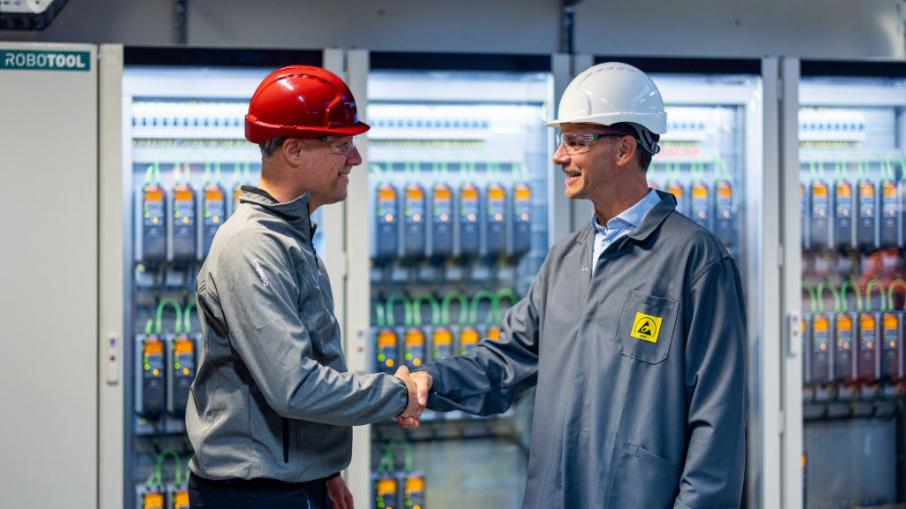 DrivePro representatives on site in front of a bank of Danfoss Drives. Maintenance, Repair and Operations (MRO) plans available from LED Controls.