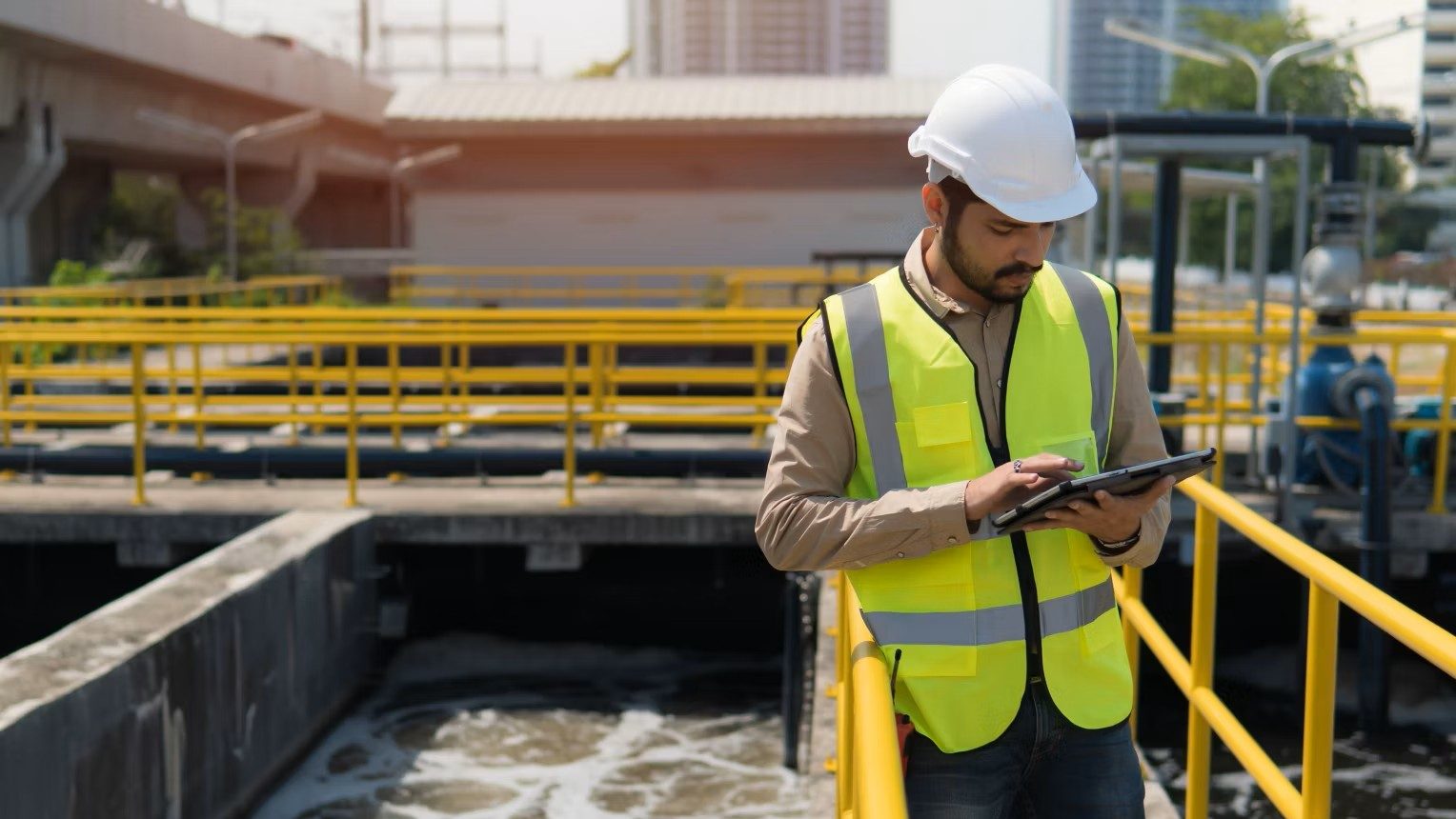 A technician at a water treatment plant uses an ABB HMI. ABB CP600 range available from LED Controls.