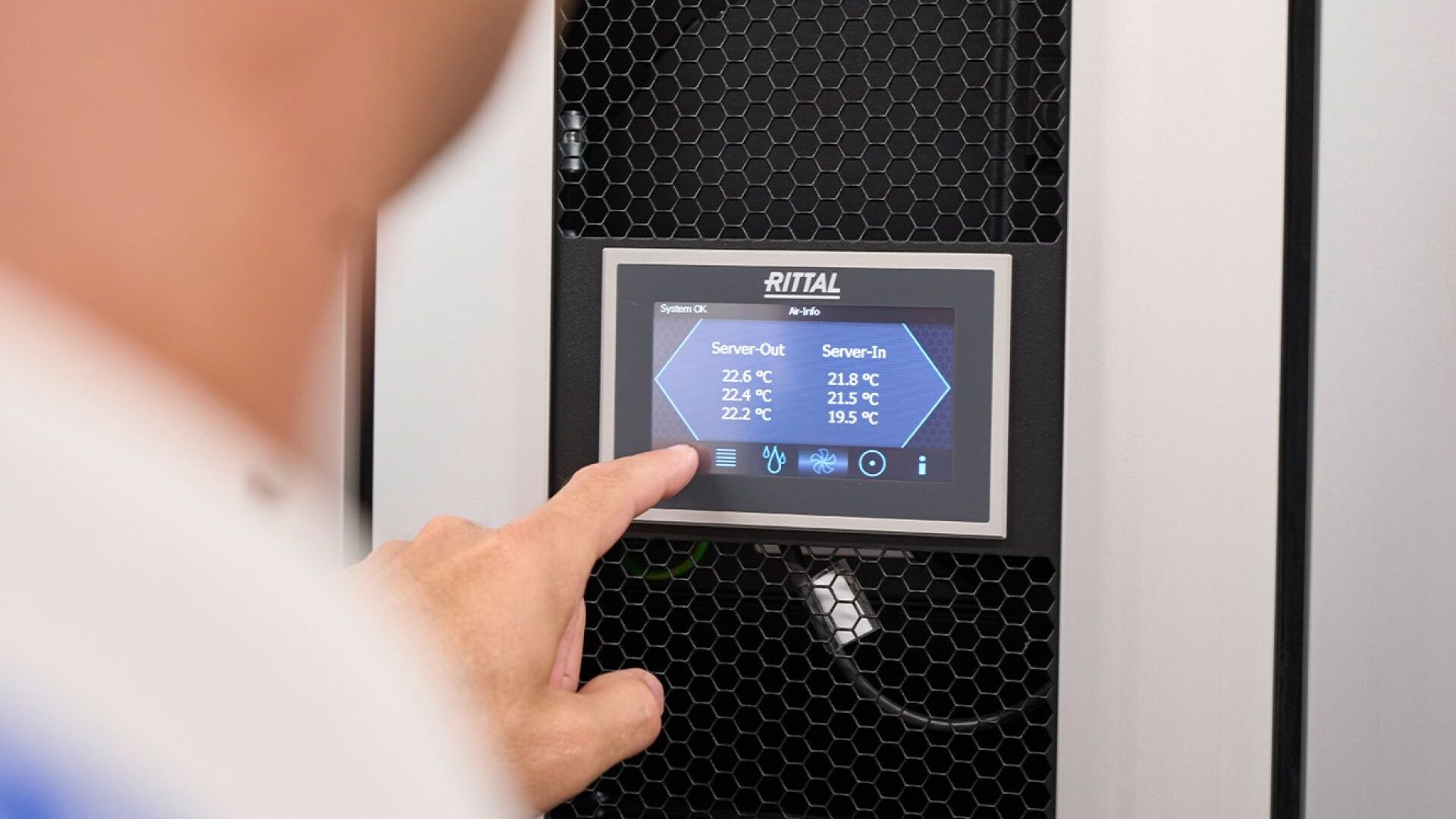A technician operating a Rittal cooling system available from LED Controls.